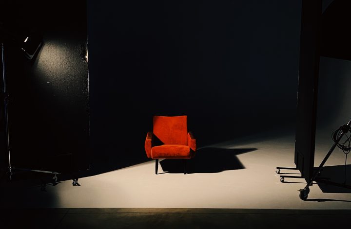 Red Chair on Spotlight Casting Shadow